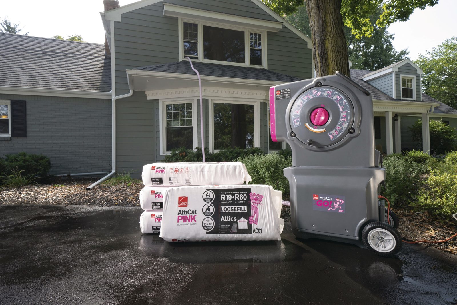 Owens Corning AttiCat blown-in insulation machine with bags of PINK insulation